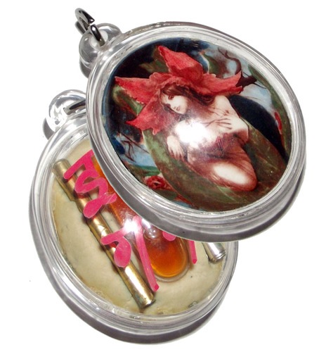 Mae Nang Dork Mai Flower Fairy Deva Locket, with double Takrut Hua Jai Maha Saneh, and a phial of concentrated ultra rare 'Nam Man Chamot'(civet oil) Sanaeh, and amulet embedded in rear face.